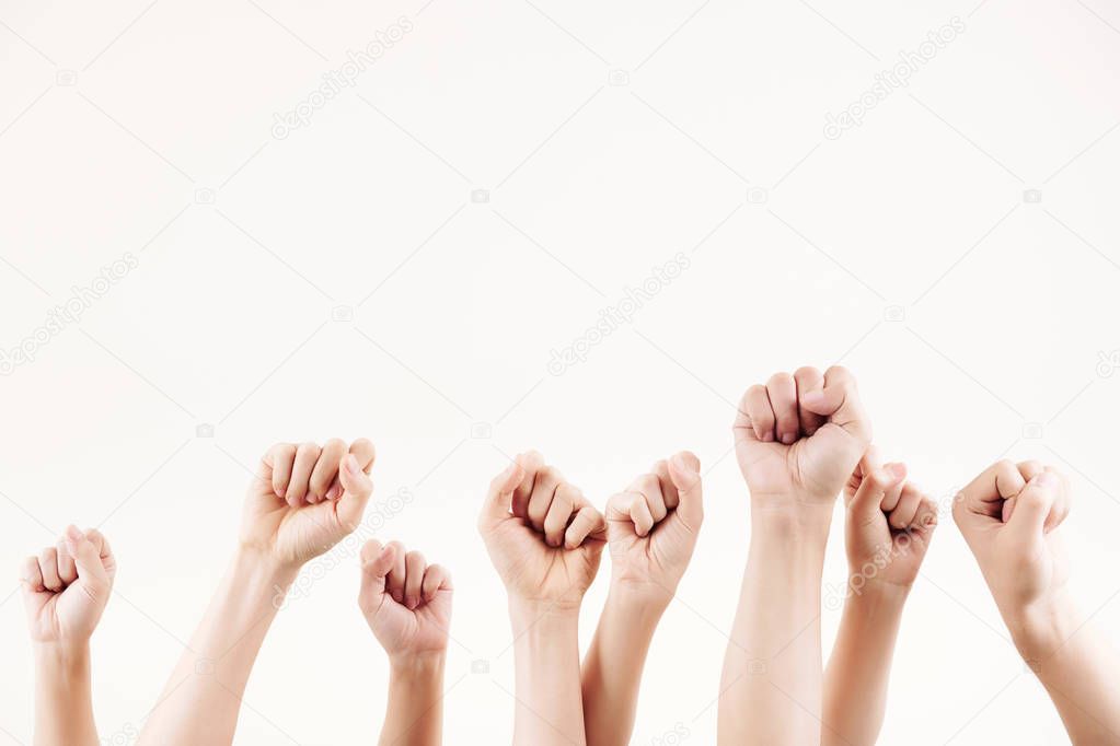 Close-up of young people raising hands up and clenching their fists isolated on white background