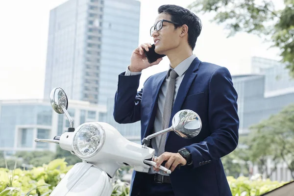 Frowning Young Asian Entrepreneur Scooter Standing Outdoors Making Phone Call — Stock Photo, Image