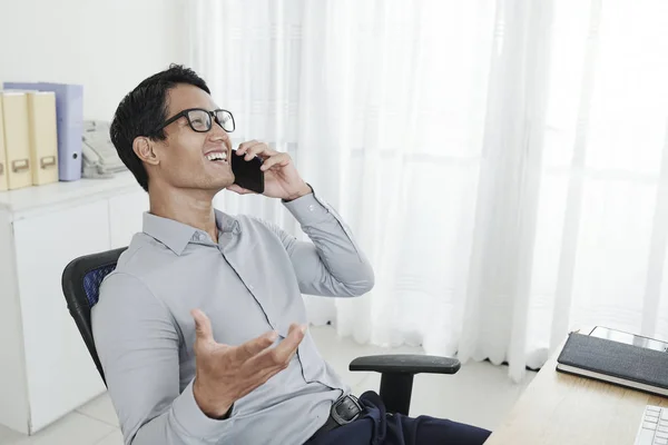 Laughing Young Vietnamese Businessman Leaning Back His Armchair Talking Mobile — Stock Photo, Image