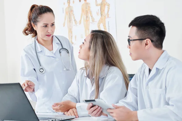 Serious Asian Doctors Sitting Table Discussing Results Patients Medical Test — Stock Photo, Image