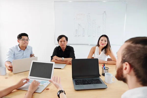 Asiáticos Colegas Negócios Sentados Mesa Ouvindo Seu Líder Masculino Atentamente — Fotografia de Stock