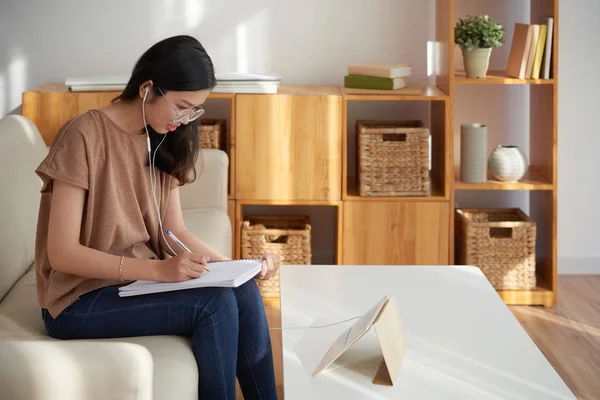 Asian Młody Kobieta Okulary Siedzący Sofa Zrobienie Notatki Notatnik Patrząc — Zdjęcie stockowe