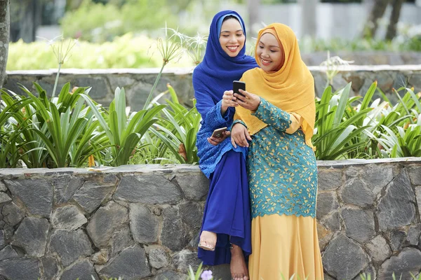 Ganska Leende Ung Asiatisk Kvinna Hijab Visar Foto Smartphone Skärmen — Stockfoto