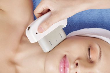 Güzellik salonunda kaldırma ve gençleştirme prosedürü zevk genç gülümseyen kadın Kırpılmış görüntü