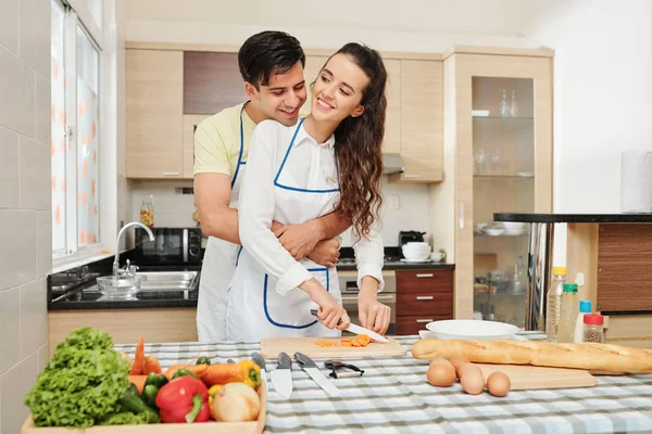 Happy Handsome Young Man Hugging His Girlfriend Who Cooking Dinner — Stock Photo, Image