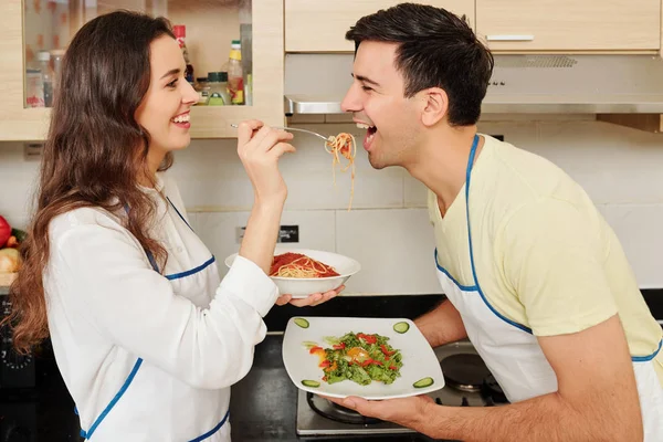 Happy Young Woman Love Feeding Her Boyfriend Spaghetti Standing Kitchen — Stock Photo, Image