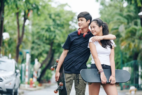 Cheerful Hugging Mixed Race Brother Sister Standing Outdoors Skateboards Hands — Stock Photo, Image