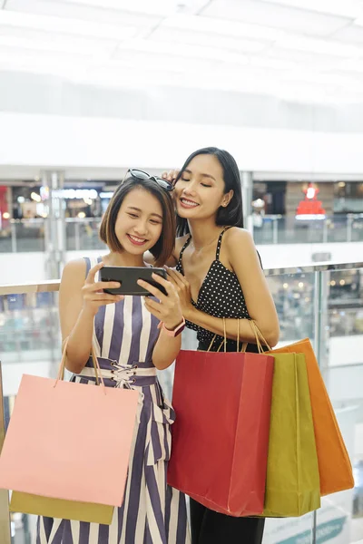 Duas Jovens Mulheres Asiáticas Com Sacos Compras Assistindo Algo Telefone — Fotografia de Stock
