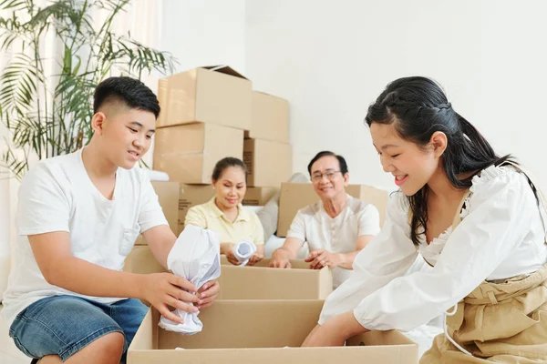 Smiling Teenage Brother Sister Wrapping Fragile Things Putting Them Cardboard — Stock Photo, Image