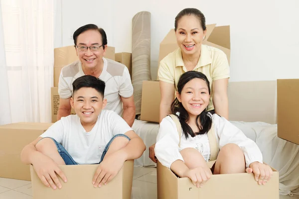 Positive Vietnamese Senior Couple New Apartment Playing Happy Grandchildren — Stock Photo, Image
