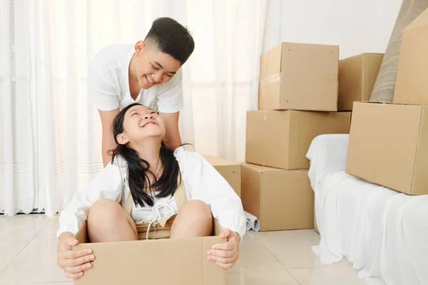 Laughing Teen Boy Pushing Cardboard Box His Happy Sister Sitting — Stock Photo, Image