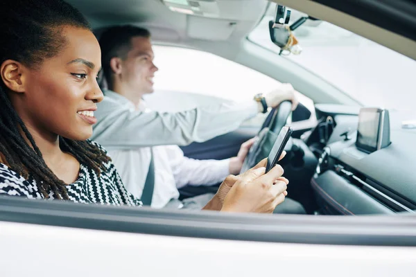 Afrikansk Ung Kvinna Läser Ett Meddelande Mobilen Och Ler Medan — Stockfoto