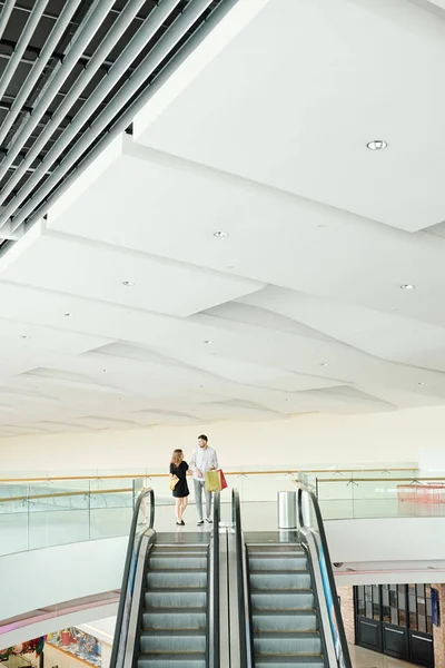 Young Couple Shopping Bags Approaching Escalator Making Purchases Shopping Mall — Stock Photo, Image