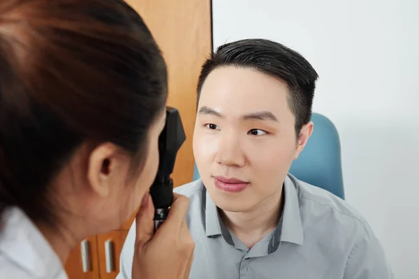 Female Doctor Examining Eyesight Her Asian Patient While Visiting Hospital — Stockfoto