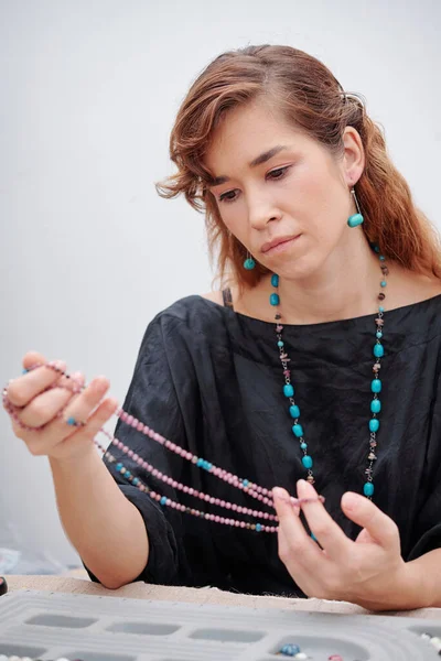 Serious Pretty Young Creative Woman Looking Amethyst Turquoise Stone Necklace — Stock Photo, Image