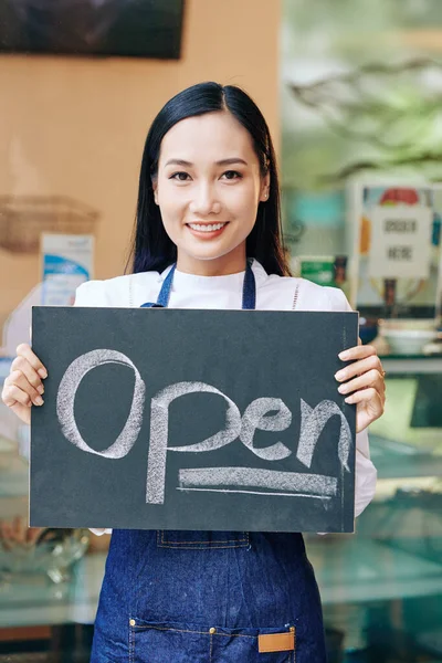 Позитивная Молодая Азиатка Джинсовом Фартуке Стоящая Кафе Показывающая Открытый Знак — стоковое фото