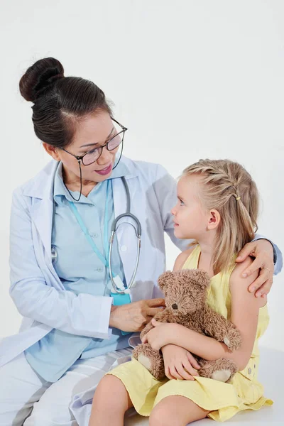 Pediatra Sonriente Abrazando Niña Para Apoyarla Tranquilizarla Antes Tomar Exámenes — Foto de Stock