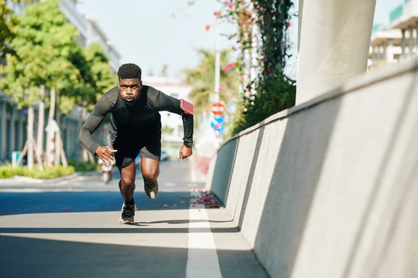 在准备三项全能运动时 英俊的运动员适合在街上跑步 — 图库照片