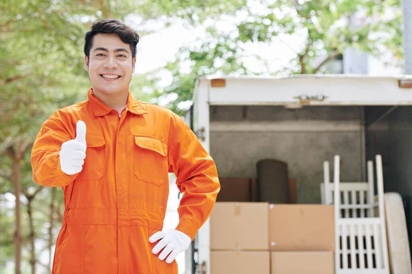 喜びアジアの移動男の横中肖像手で明るいオレンジ色の制服立って屋外の挨拶の顧客を身に着けています コピースペース — ストック写真