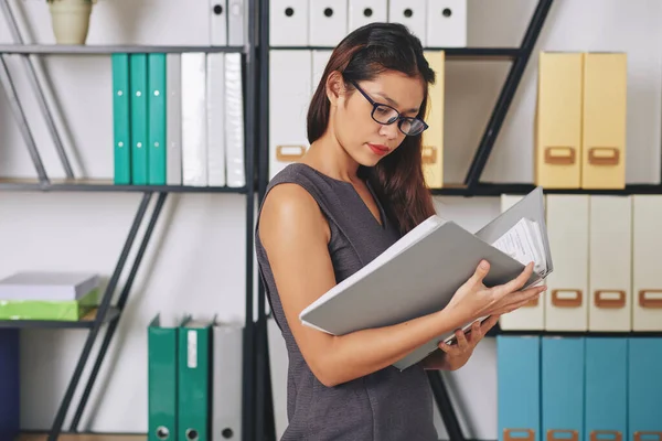 Serious Young Businesswoman Glasses Standing Office Archive Searching Document Thick — Stock Photo, Image