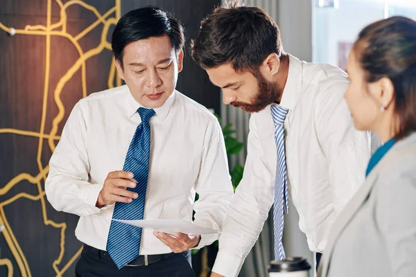Serious Mature Entrepreneur Pointing Financial Report Talking Colleagues Meeting — Stock Photo, Image