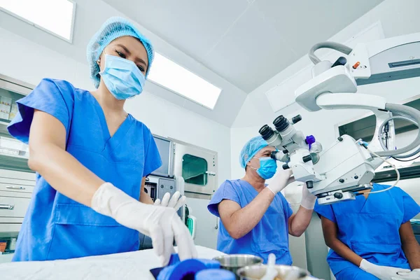 Chirurg Pracující Moderním Vybavení Když Jeho Asistent Připravuje Nástroje Zdravotnické — Stock fotografie