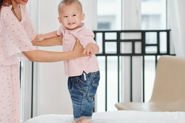 Cute Happy Little Boy Leaning Arms His Mother Standing Bed — ストック写真