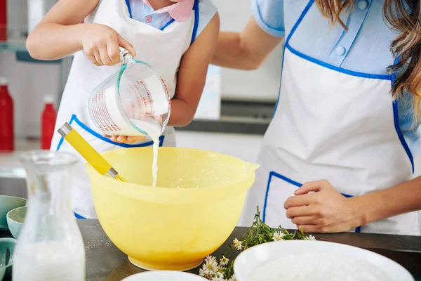 Mother Daughter Apron Pouring Warm Milk Bowl Making Cookie Dough — Stock Photo, Image