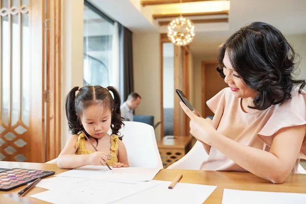 Sorrindo Mulher Vietnamita Fotografar Sua Filha Pintura Mesa — Fotografia de Stock