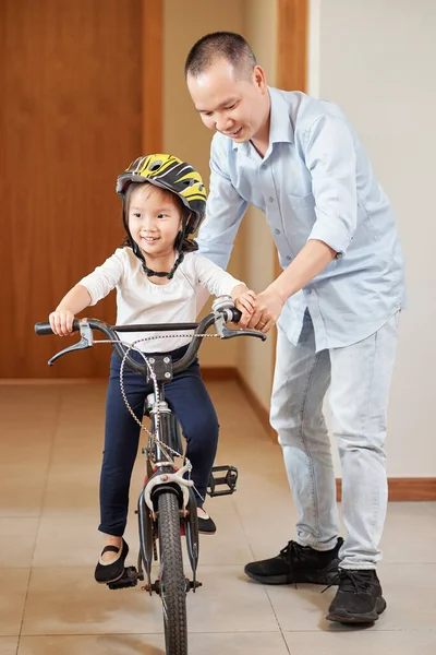 Happy Vietnamese Man Teaching Little Daughter How Ride Bicycle Apartment — Stock Photo, Image
