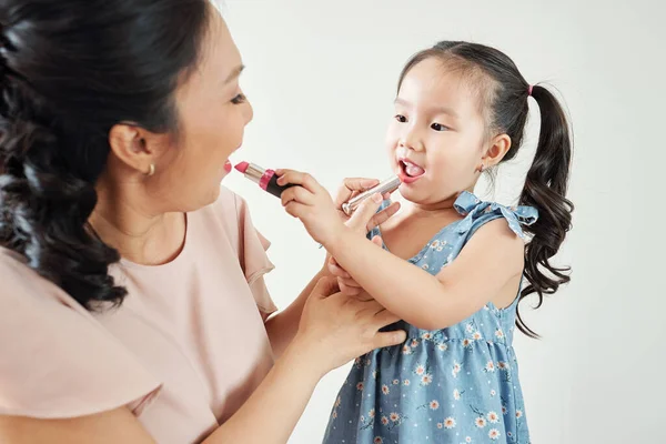 Cheerful Asian Mother Daughter Applying Lipsticks Lips Each Other Getting — Stock Photo, Image