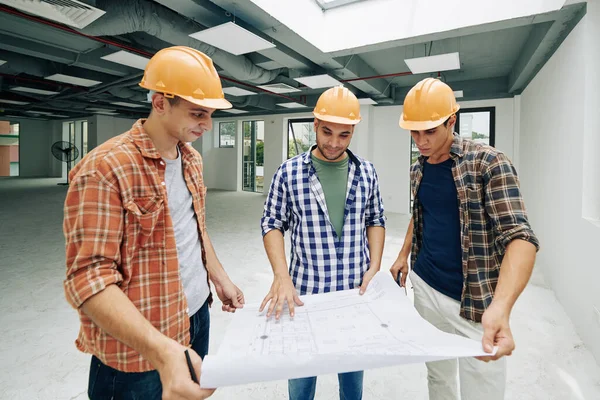 Grupo Jóvenes Trabajadores Construcción Sonrientes Comprobando Llanura Construcción Distribución Trabajo — Foto de Stock