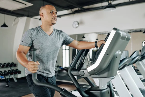 Serious Mature Mixed Race Man Working Out Elliptical Machine Gym — Stock Photo, Image