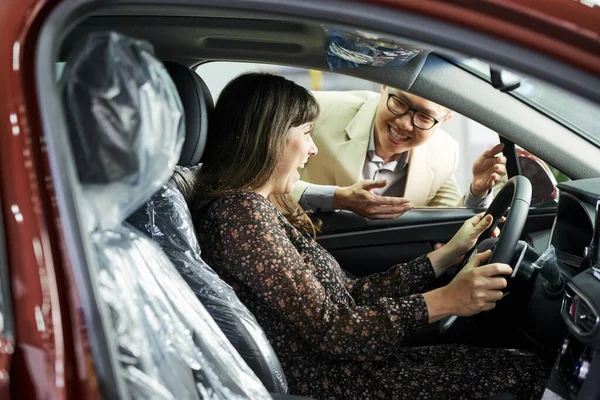 Happy Woman Sitting New Car Satisfied Her Purchase Salesman Standing — Stock Photo, Image
