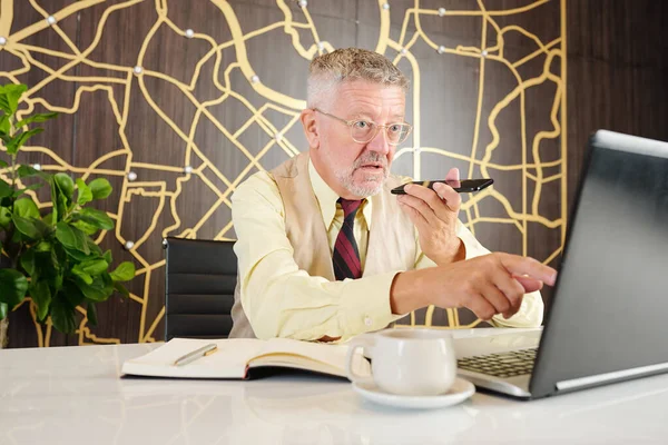 Indignant Senior Entrepreneur Reading Report Laptop Screen Recording Voice Message — Stock Photo, Image