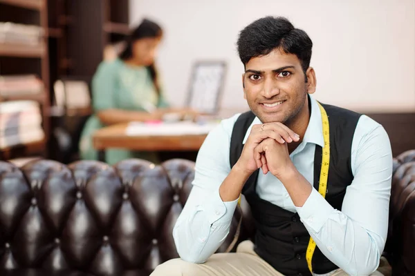 Portrait Smiling Handsome Young Indian Tailor Measuring Tape Sitting Sofa — Stock Photo, Image