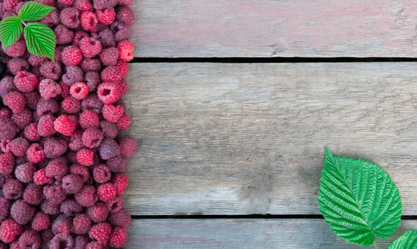 Raspberries on a wooden background