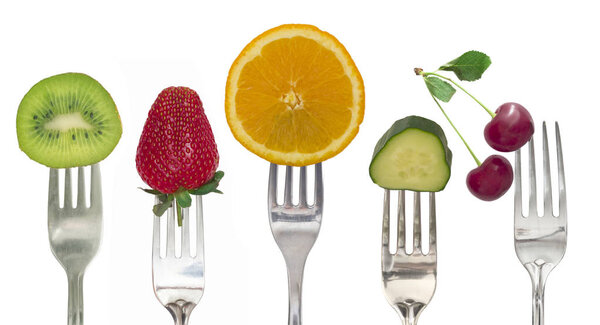 Diet concept, vegetables and fruit on the forks