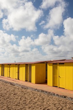 Yaz tatil yeri. Güzel parlak canlı sarı banyo kumlu sahilde ev sahipliği yapmaktadır. Boş sığınak bir güneşli ama huysuz gününde. Seaside mimarisi, boya renkli. Evsiz Peyzaj sahne. Yoksulluk ve yalnızlık kavramı. Cennet.