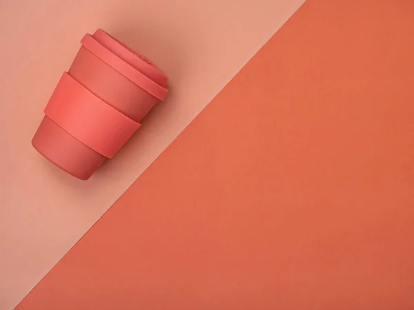 Taza de café en color coral sobre fondo simple . — Foto de Stock