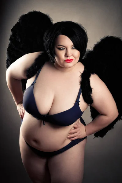 sensual fat woman in black lingerie with black wings