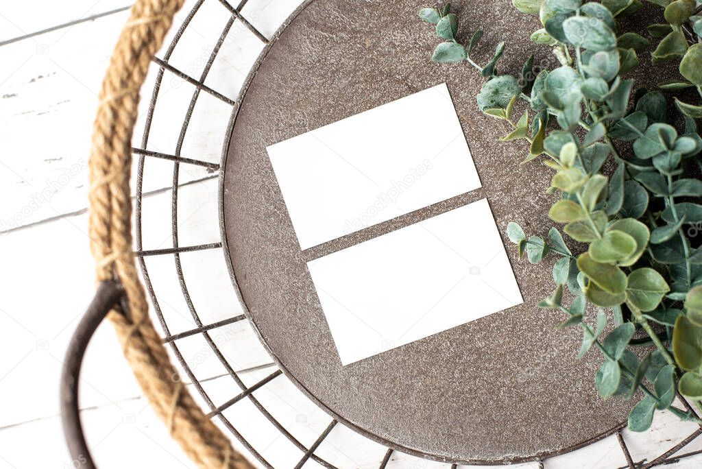 Mock-up for branding identity. Photo of blank white business cards. Blank cards for portfolio and project presentation. Metal vintage basket background