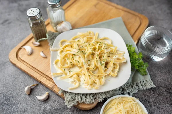 Alfredo pasta dinner with creamy white sauce and herbs