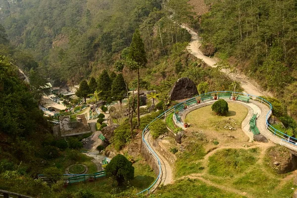Top view of Barbotey Rock Garden in the mountains. Public natural park outdoors with curved walkways. Popular tourist attraction and Indian landmark near Darjeeling, India