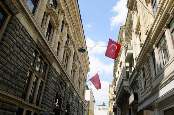 Big Turkish flags waving on the government buildings in the Galata tower district in Istanbul. Turkey