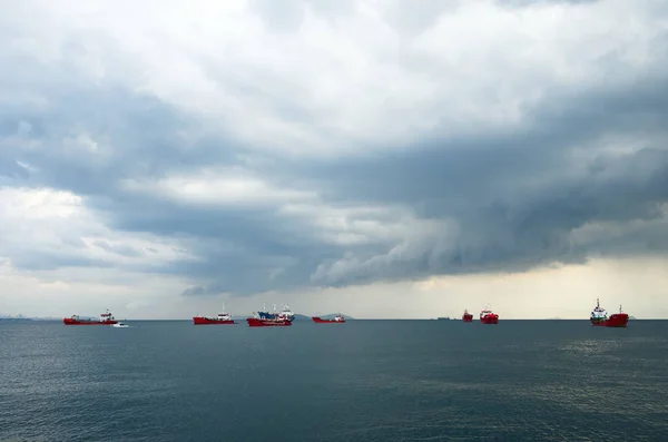Overcast sky with clouds over freight ships in harbor in Marmara Sea near Istanbul city, Turkey.