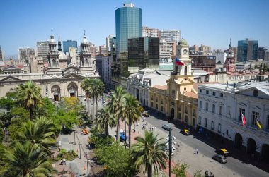 Santiago, Şili - Şubat 2020: Güneşli bir günde çatıdan Santiago de Şili 'nin ana şehir meydanı Plaza de Armas manzarası. Santiago Metropolitan Katedrali ve Ulusal Tarih Müzesi. Şehrin ufuk çizgisi görünümü