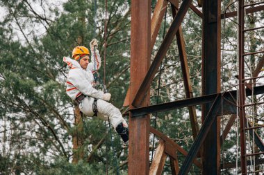 Endüstriyel dağcı üniforma ve kask yüksekliği açık havada üzerinde çalışıyor. Profesyonel çalışan su kulesi riskli onun işi. 