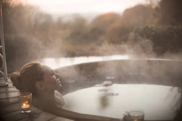 Serene Vrouw Onderdompelen Stomende Hot Tub Met Herfst Boomstructuurweergave — Stockfoto