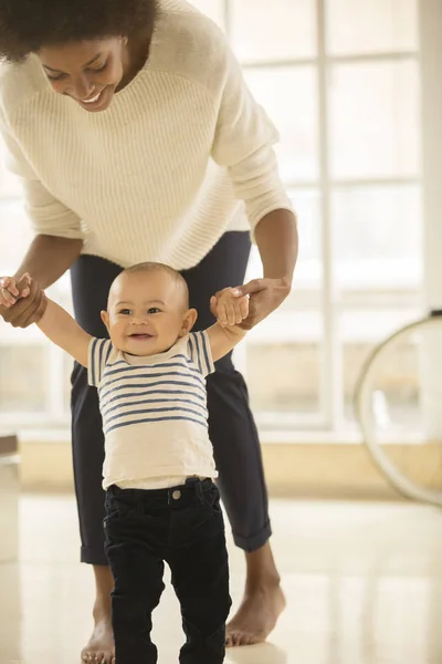 Mother Helping Baby Boy Walk Floor Home — Stock Photo, Image